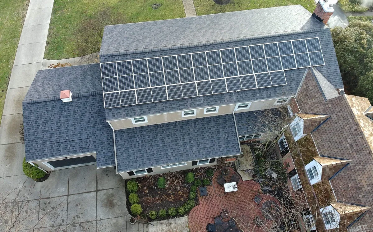 Drone view of a finished full roof replacement, solar panels reinstalled.